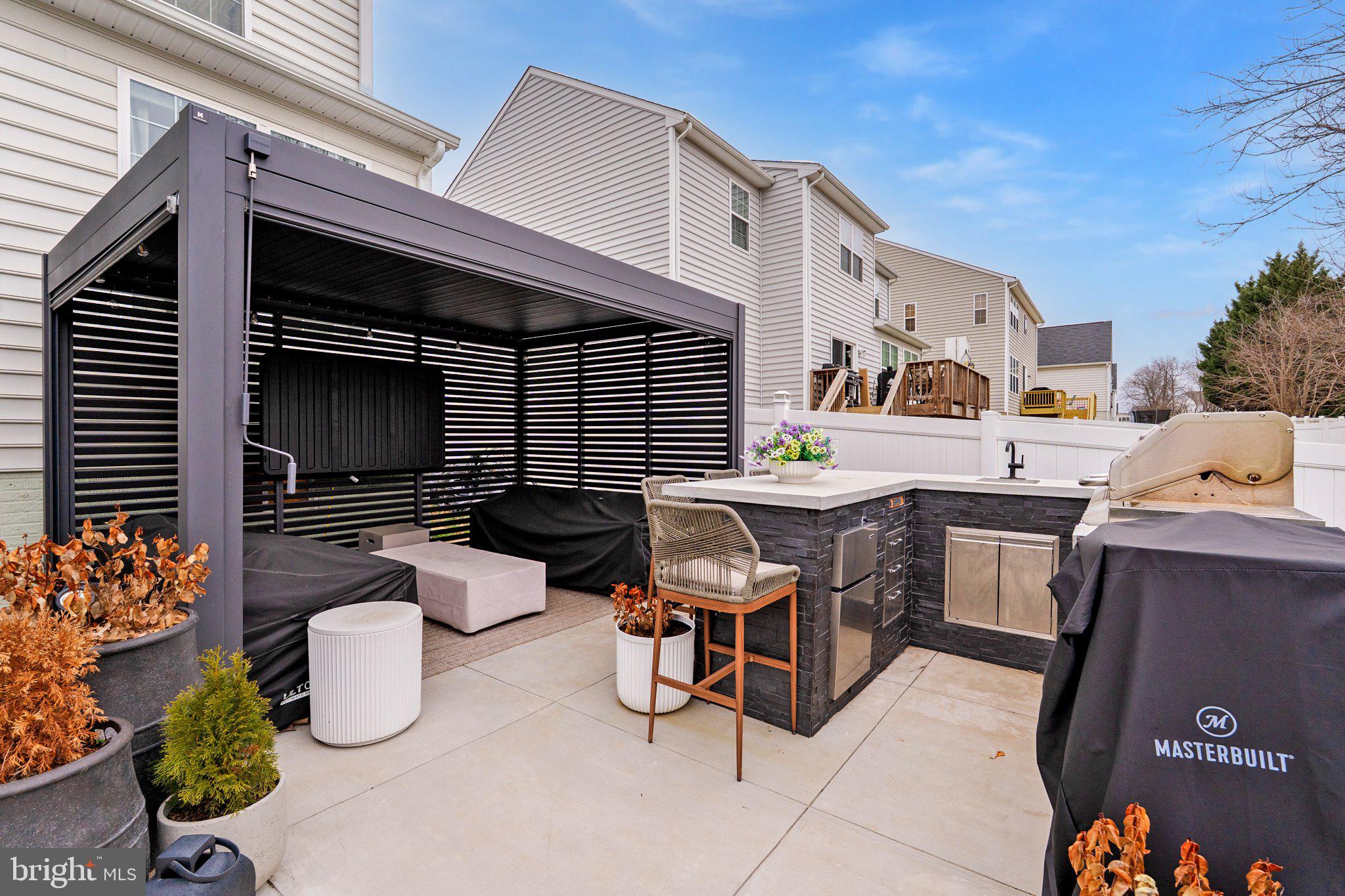 38 Deep Creek Road Ranson, WV 25438 - Photo 63 of 64 a view of a patio with dining table and chairs potted plants