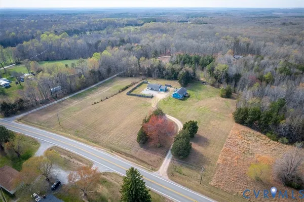 an aerial view of a house with a yard