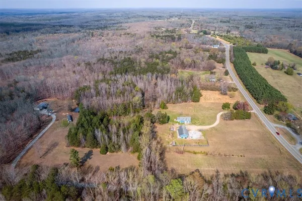 an aerial view of a house with a yard