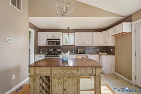 a kitchen with a stove a sink and a microwave