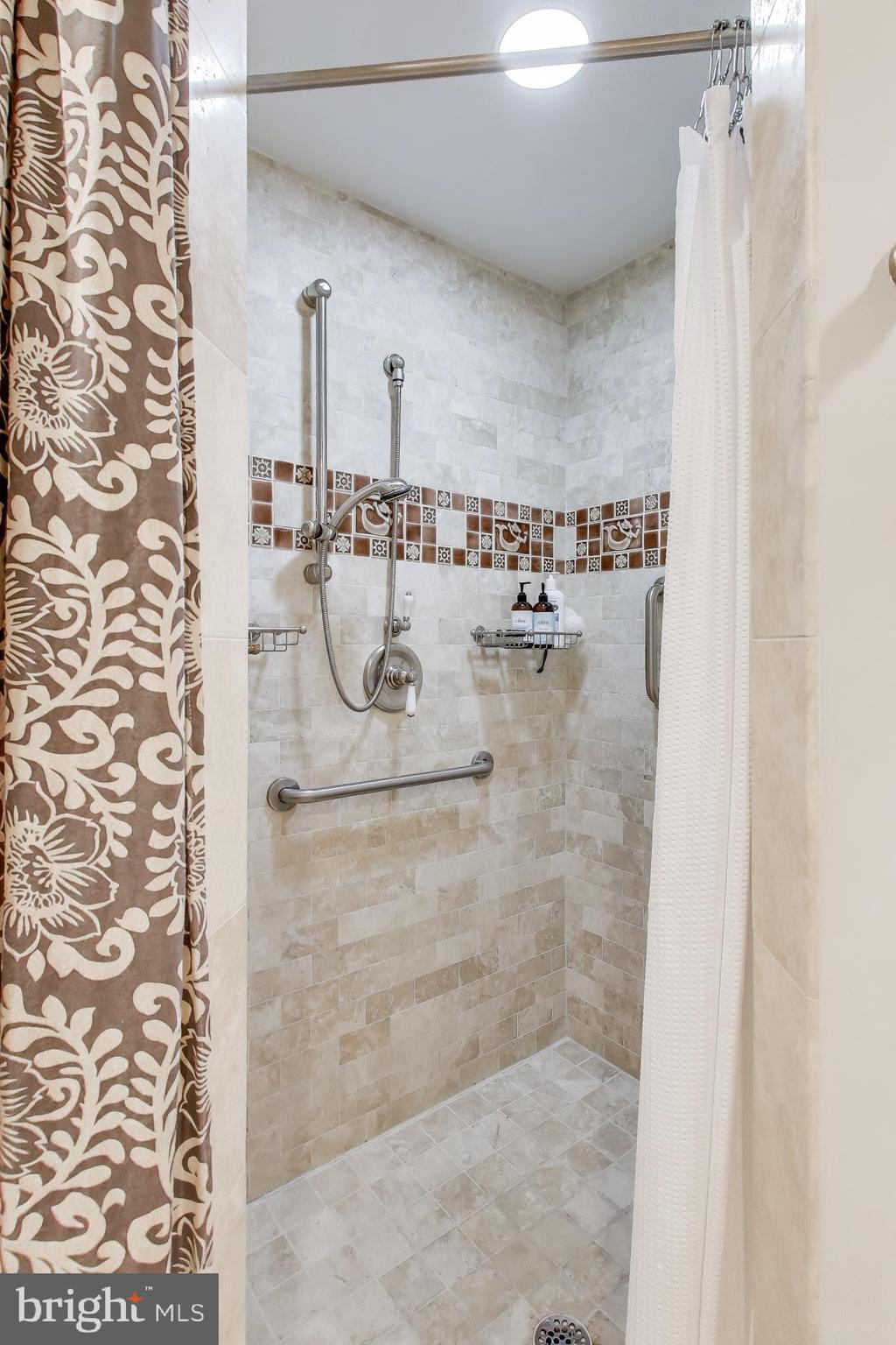 7405 Arlington Road, Unit 202 Bethesda, MD 20814 - Photo 30 of 41 Stone tiles throughout the bathroom