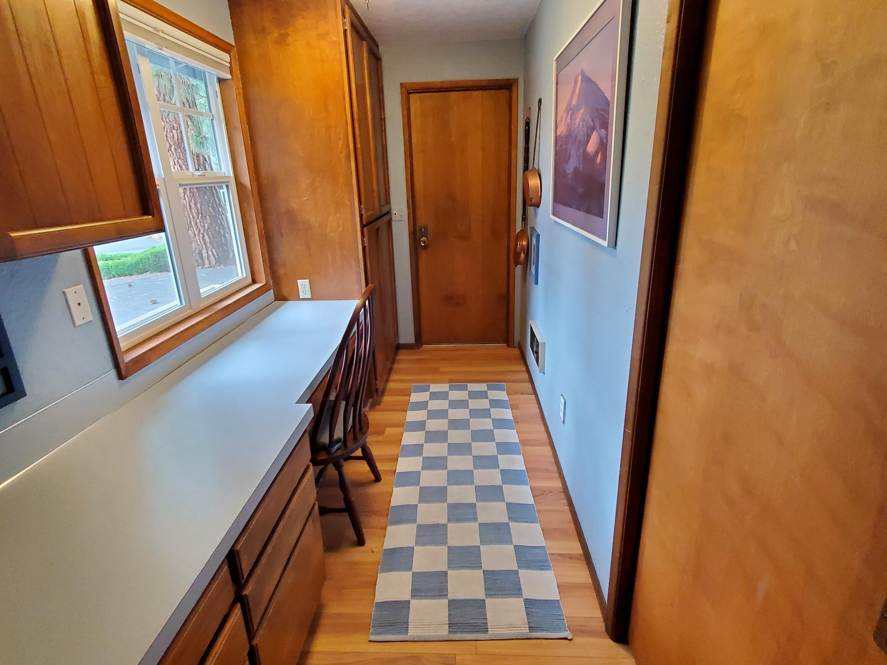 20397 Strawline Road Bend, OR 97702 - Photo 20 of 25 Enter in from the garage into this well arranged room featuring a desk area, lots of countertop, cabinets for storage plus a closet.