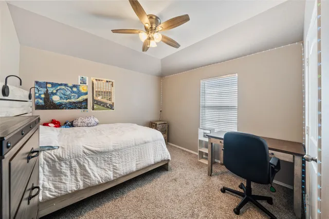 a bedroom with a bed chair and a window