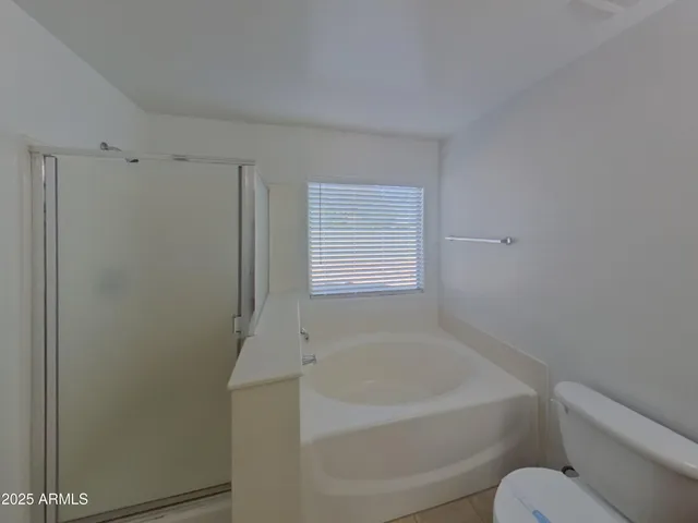a white bath tub sitting next to a toilet