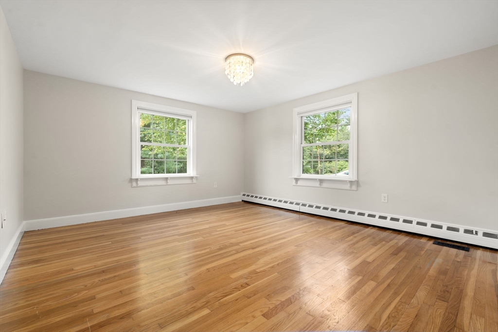 92 Abbot Street Andover, MA 01810 - Photo 20 of 35 a view of an empty room with wooden floor and a window