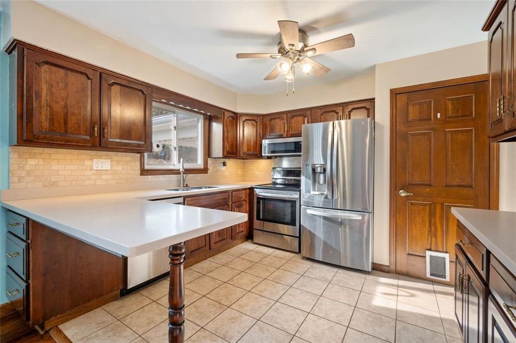 2425 Highway 30 Hookstown, PA 15050 - Photo 6 of 28 a kitchen with kitchen island granite countertop a stove refrigerator and cabinets