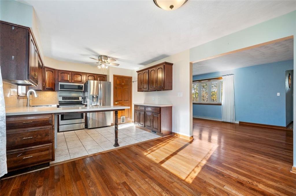 2425 Highway 30 Hookstown, PA 15050 - Photo 7 of 28 a open kitchen with stainless steel appliances kitchen island granite countertop a stove top oven and sink