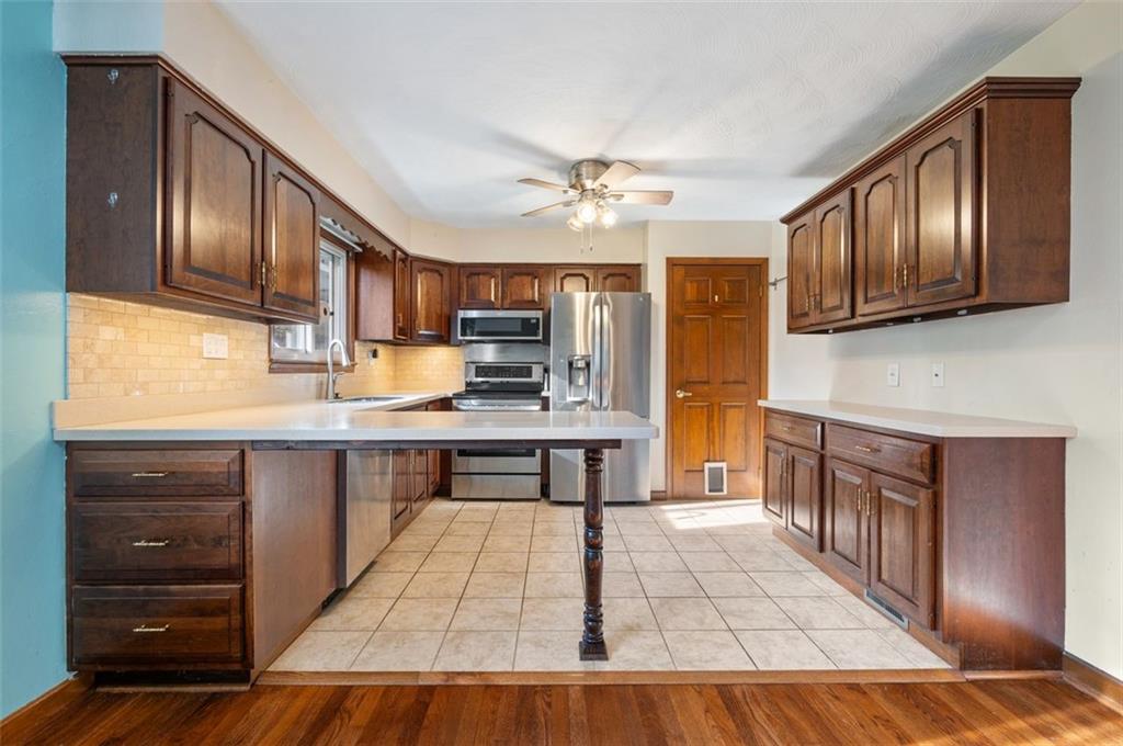 2425 Highway 30 Hookstown, PA 15050 - Photo 8 of 28 a kitchen with stainless steel appliances granite countertop wooden cabinets a stove top oven a sink and dishwasher