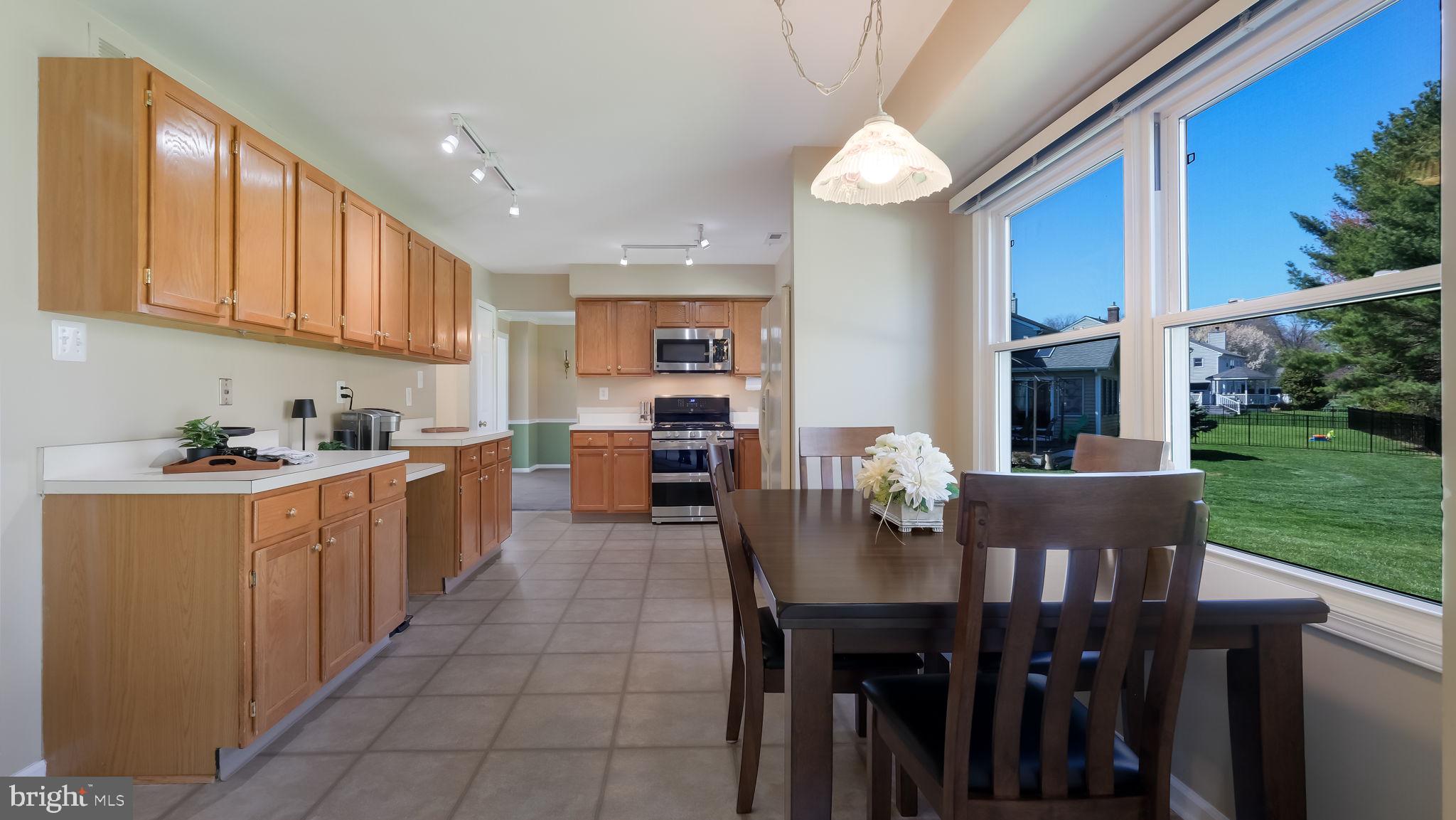 9 Caldwell Circle Newtown, PA 18940 - Photo 11 of 29 a kitchen with stainless steel appliances granite countertop a table chairs sink and cabinets