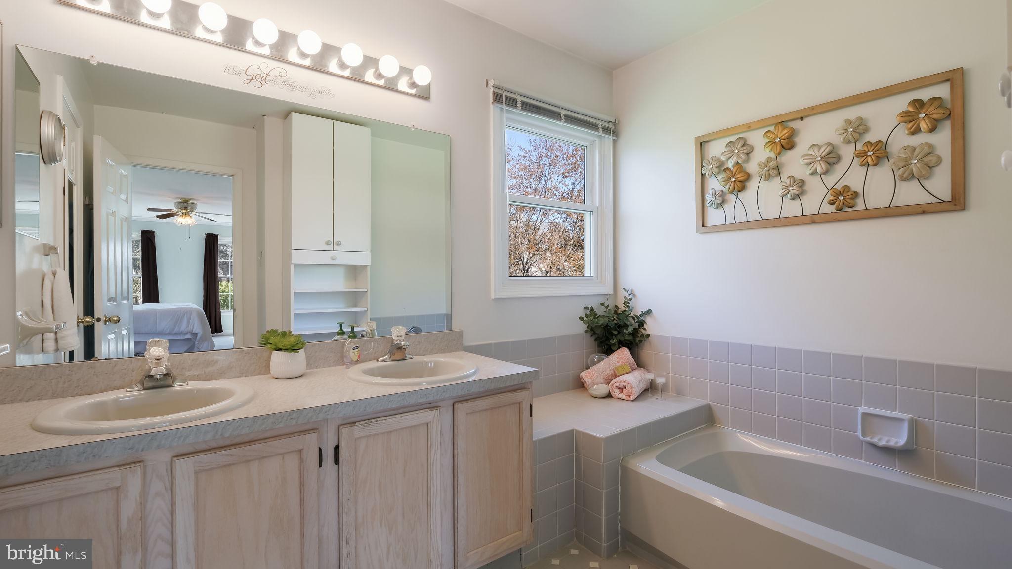9 Caldwell Circle Newtown, PA 18940 - Photo 18 of 29 a bathroom with a sink a tub and a mirror