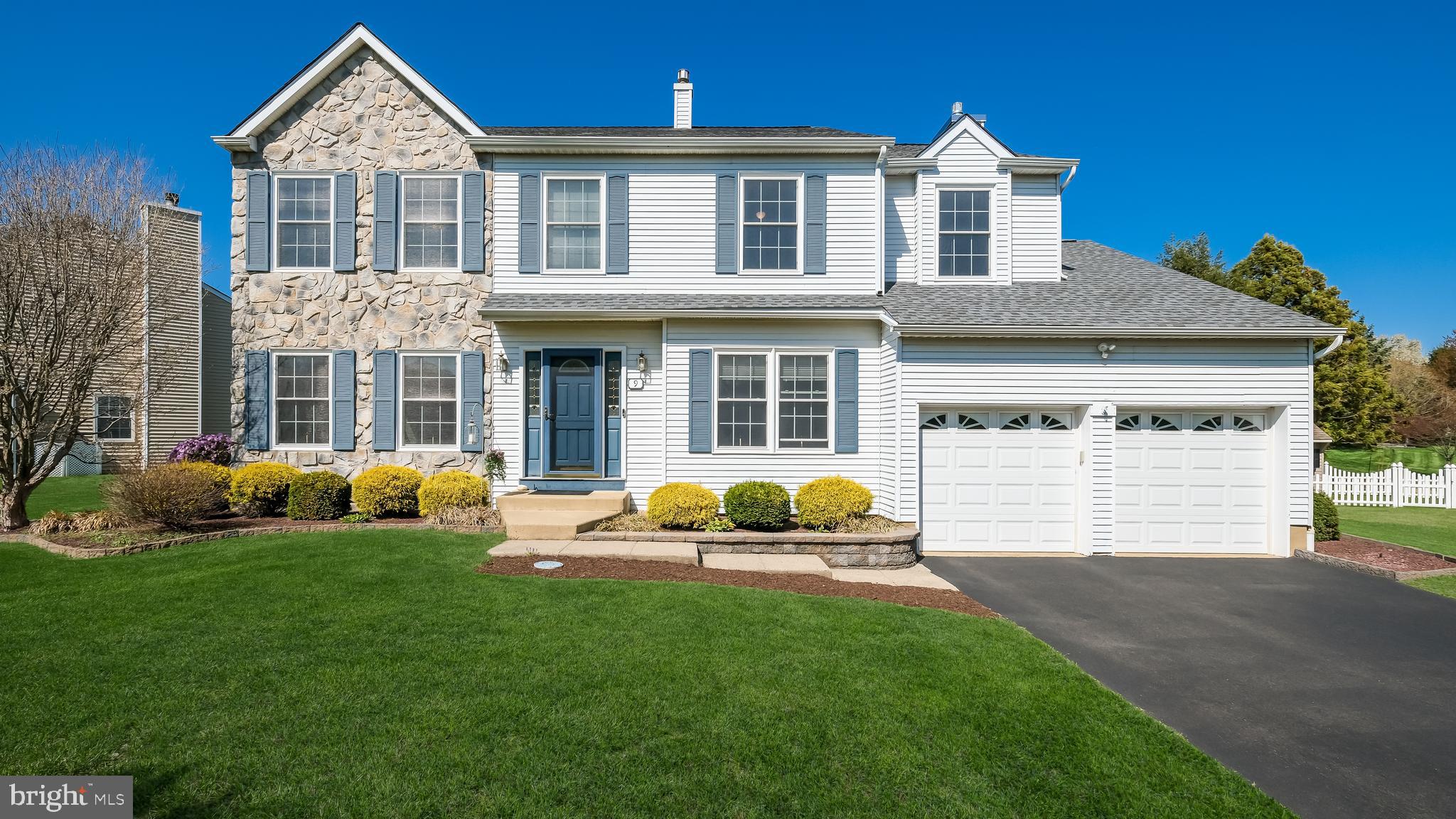 9 Caldwell Circle Newtown, PA 18940 - Photo 2 of 29 a front view of a house with a garden and yard