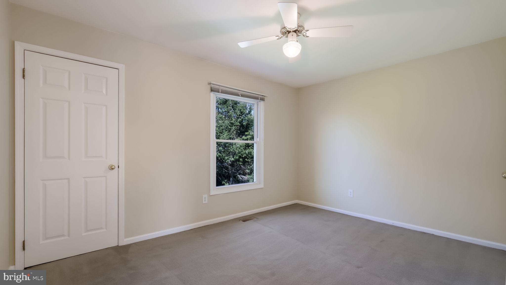 9 Caldwell Circle Newtown, PA 18940 - Photo 22 of 29 an empty room with a window and a fan