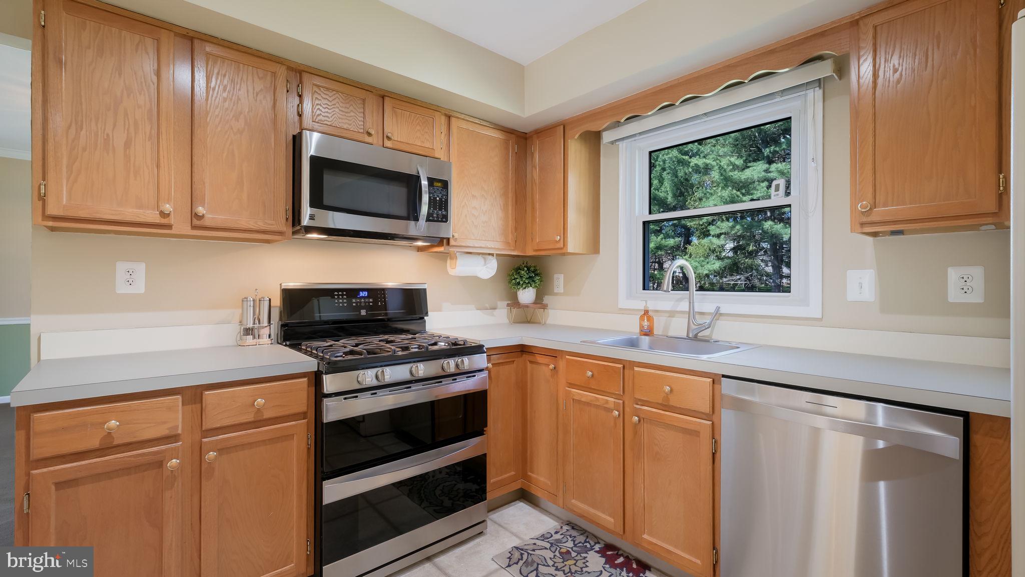 9 Caldwell Circle Newtown, PA 18940 - Photo 9 of 29 a kitchen with stainless steel appliances granite countertop white cabinets and a stove top oven