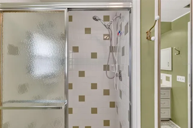 a bathroom with a glass door shower