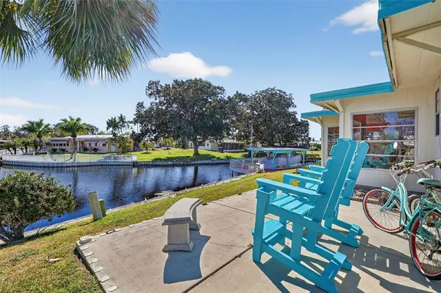 a view of swimming pool with outdoor seating and plants