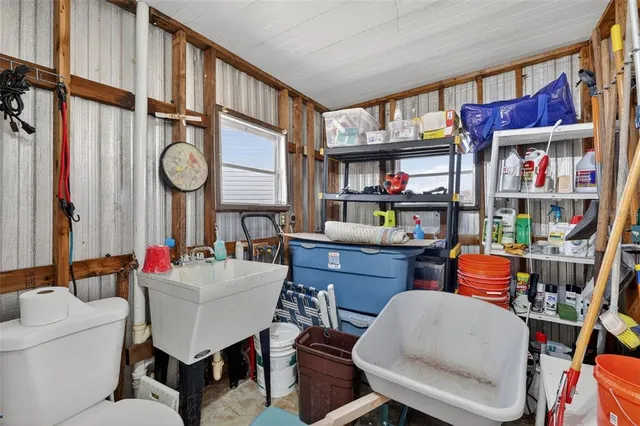a living room with furniture and a book shelf