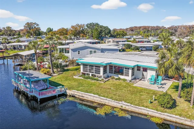 an aerial view of a house with a garden and outdoor seating