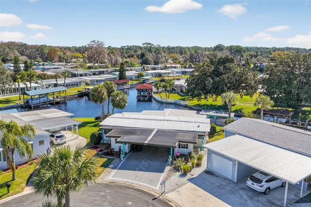 a view of a chairs and table in patio with a lake view
