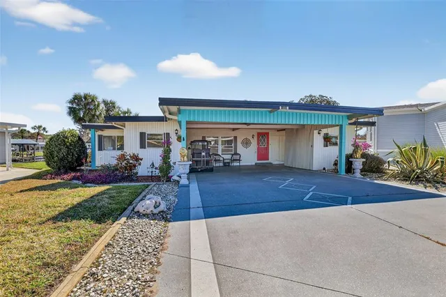 a view of a house with a yard and plants