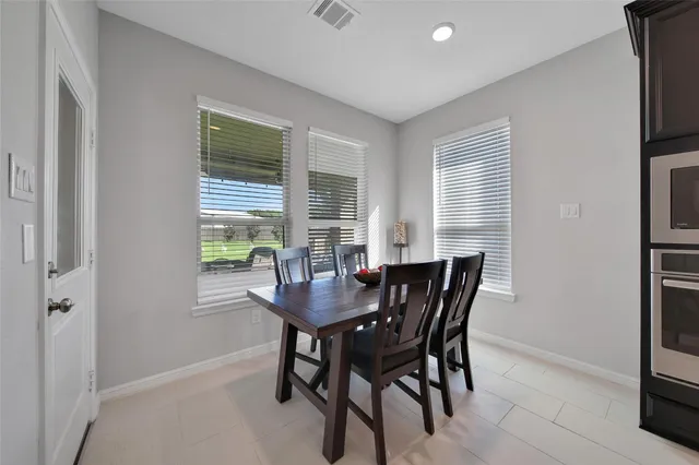 a view of a dining room with furniture and a window