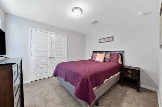 a bedroom with a bed and a tv