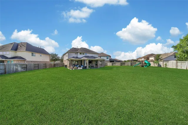 a view of a house with a yard and sitting area