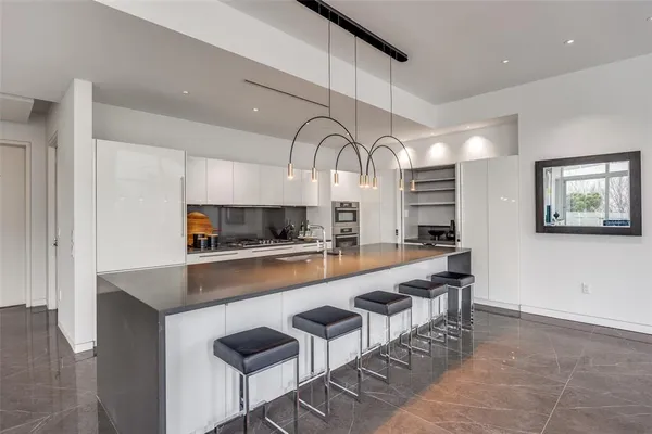 a large kitchen with lots of counter space and furniture