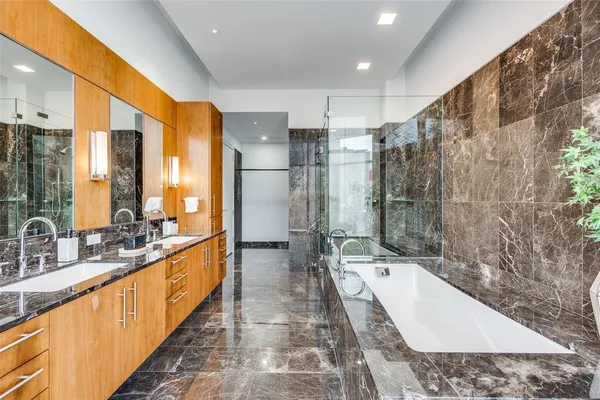 a bathroom with a double vanity sink and a mirror