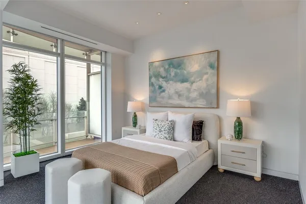 a bedroom with a large bed and a large window