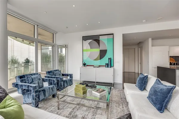 a living room with furniture fireplace and a large window