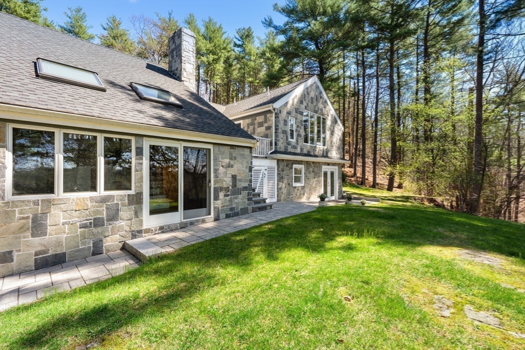 40 Hobbs Brook Road Weston, MA 02493 - Photo 22 of 42 a view of a house with a yard and sitting area