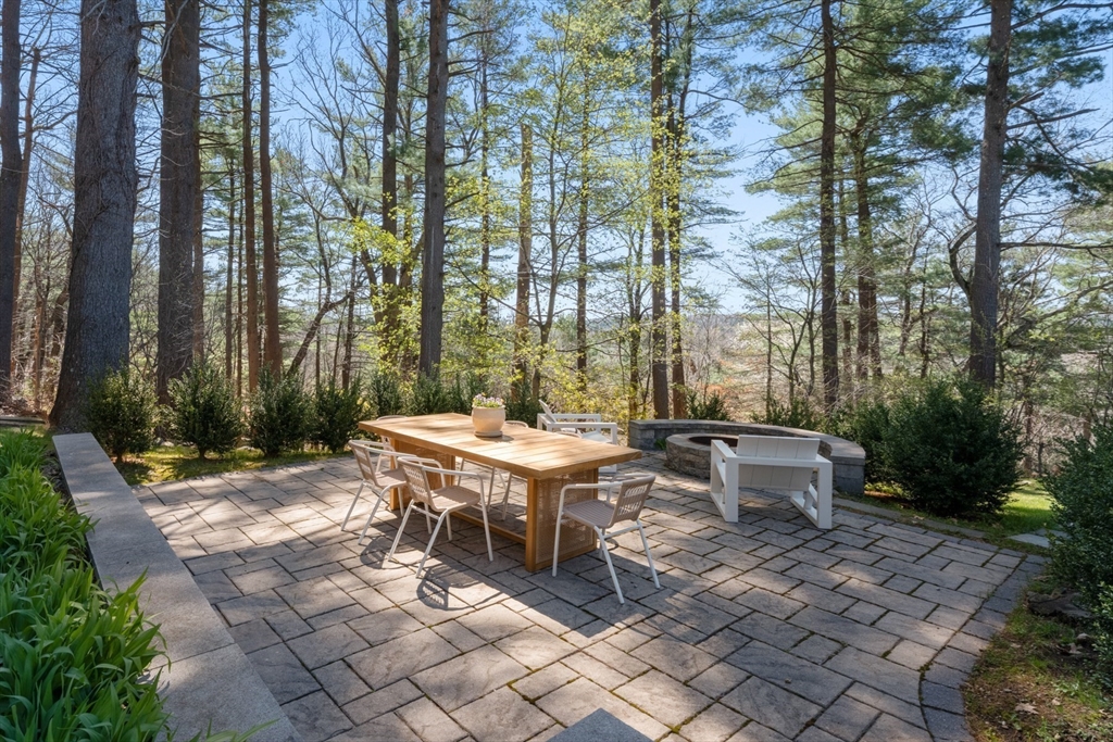 40 Hobbs Brook Road Weston, MA 02493 - Photo 26 of 42 a view of a dinning table and chair in the backyard