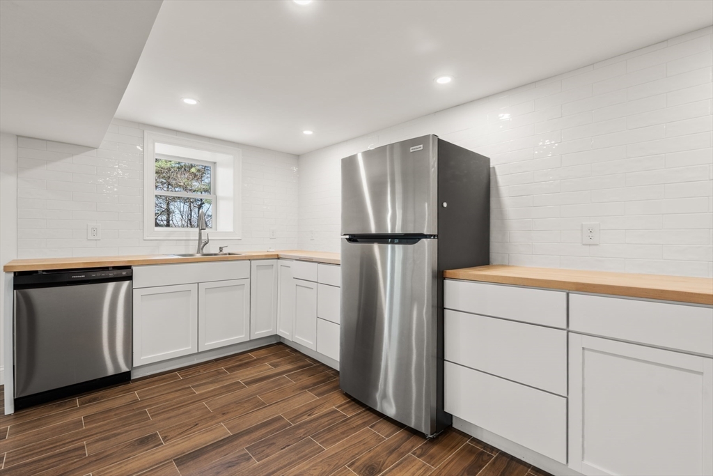 40 Hobbs Brook Road Weston, MA 02493 - Photo 33 of 42 a kitchen with a refrigerator sink and cabinets