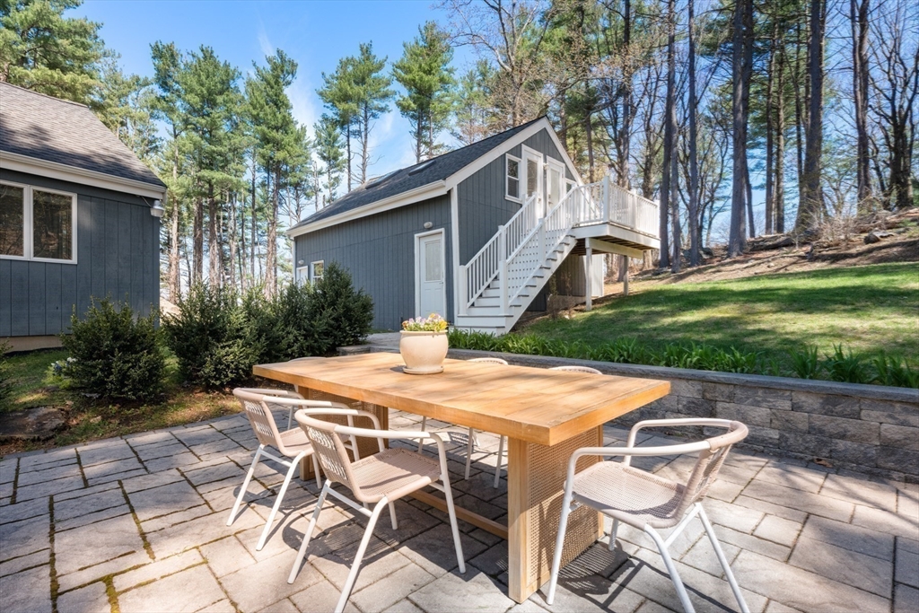 40 Hobbs Brook Road Weston, MA 02493 - Photo 34 of 42 a patio with table and chairs and potted plants