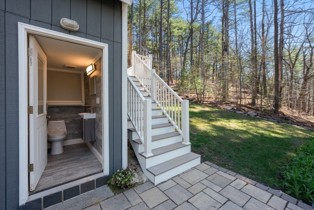 40 Hobbs Brook Road Weston, MA 02493 - Photo 36 of 42 a view of a porch with a table and chairs next to a yard