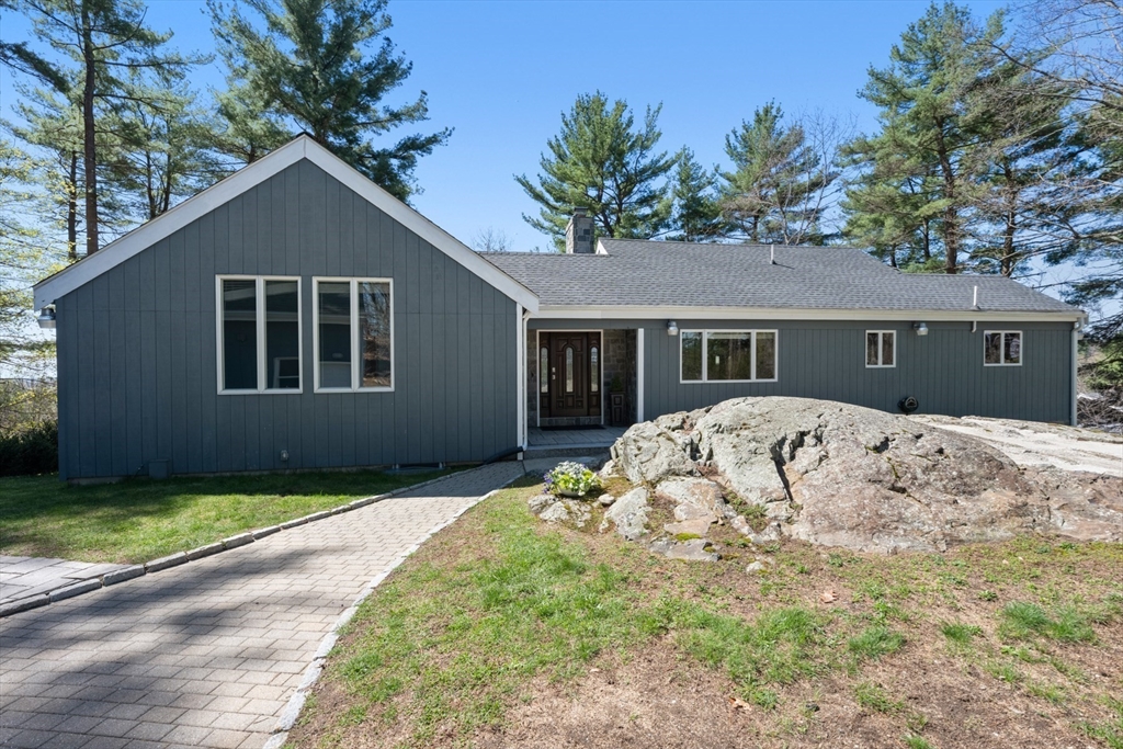 40 Hobbs Brook Road Weston, MA 02493 - Photo 40 of 42 a front view of a house with a garden