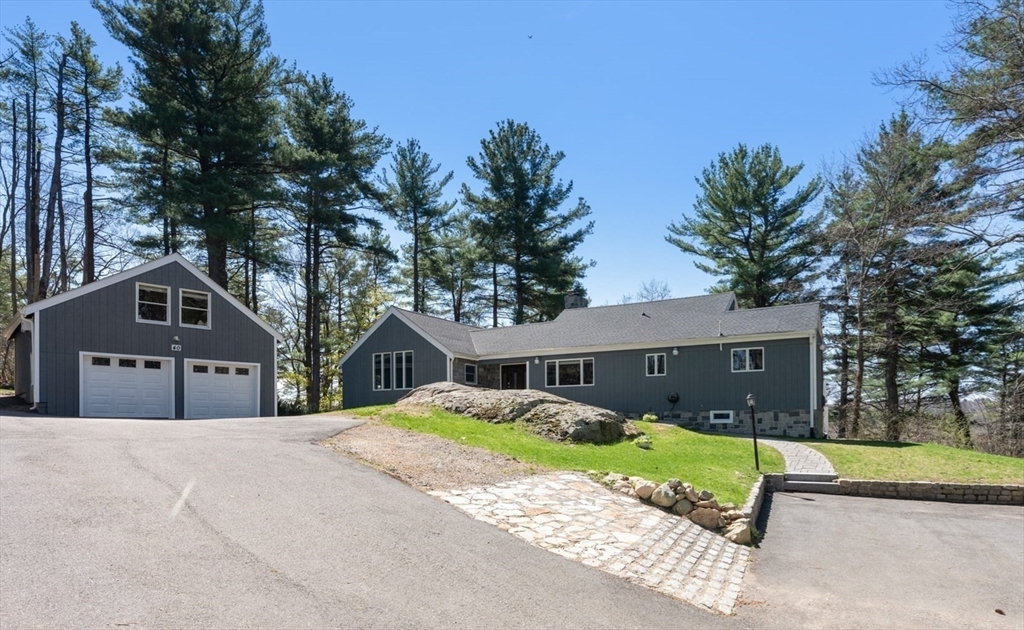 40 Hobbs Brook Road Weston, MA 02493 - Photo 41 of 42 a front view of a house with a yard and garage