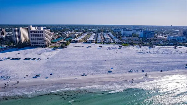 a view of a dry yard with wooden fence
