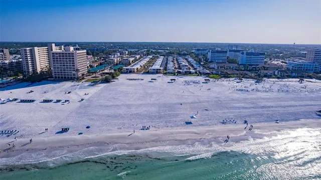 a view of a dry yard with wooden fence