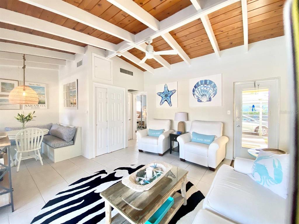 6006 Midnight Pass Road, Unit 71 Sarasota, FL 34242 - Photo 2 of 21 a bedroom with furniture and a large window