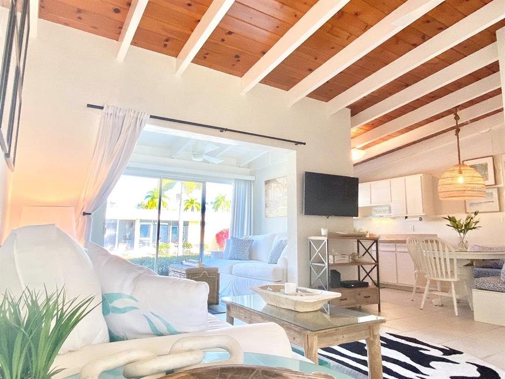 6006 Midnight Pass Road, Unit 71 Sarasota, FL 34242 - Photo 4 of 21 a living room with furniture and a large window