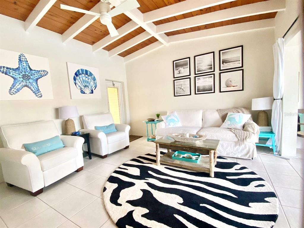 6006 Midnight Pass Road, Unit 71 Sarasota, FL 34242 - Photo 5 of 21 a living room with furniture and a rug