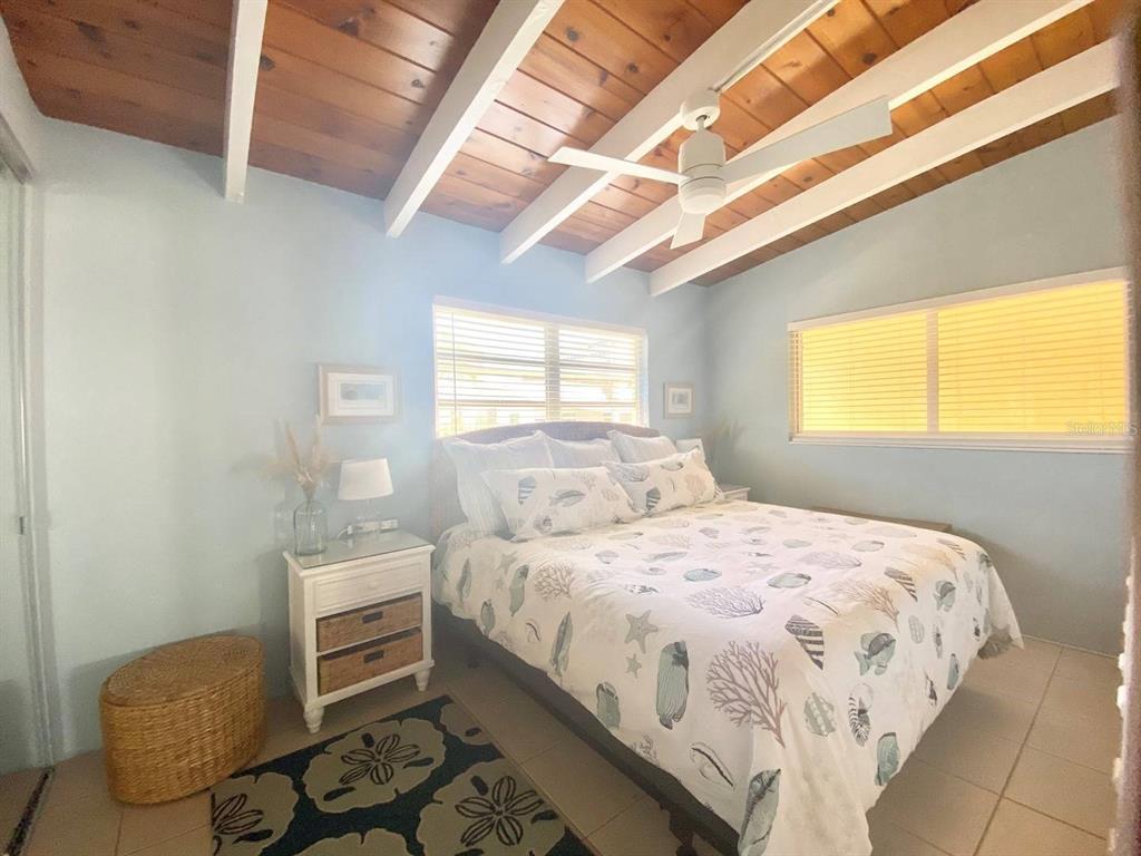 6006 Midnight Pass Road, Unit 71 Sarasota, FL 34242 - Photo 8 of 21 a bedroom with a bed and a window