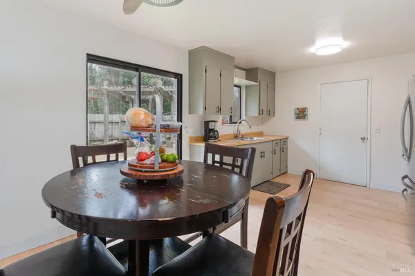 a view of a dining room with furniture and chandelier