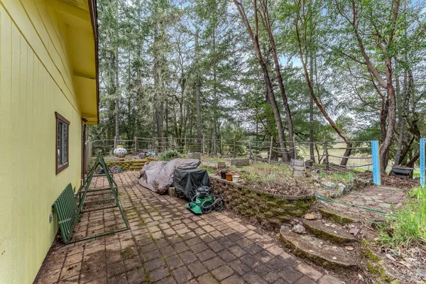 a backyard of a house with table and chairs