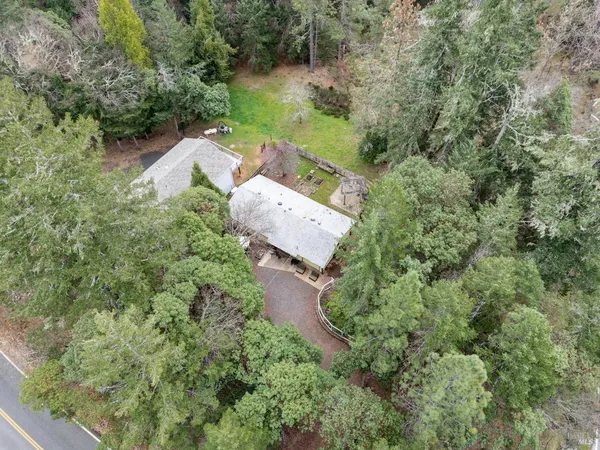 an aerial view of a house with a yard and outdoor seating
