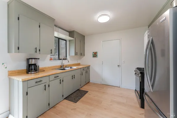 a kitchen with a sink and refrigerator
