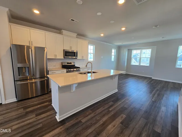 a kitchen with stainless steel appliances a refrigerator stove microwave and cabinets