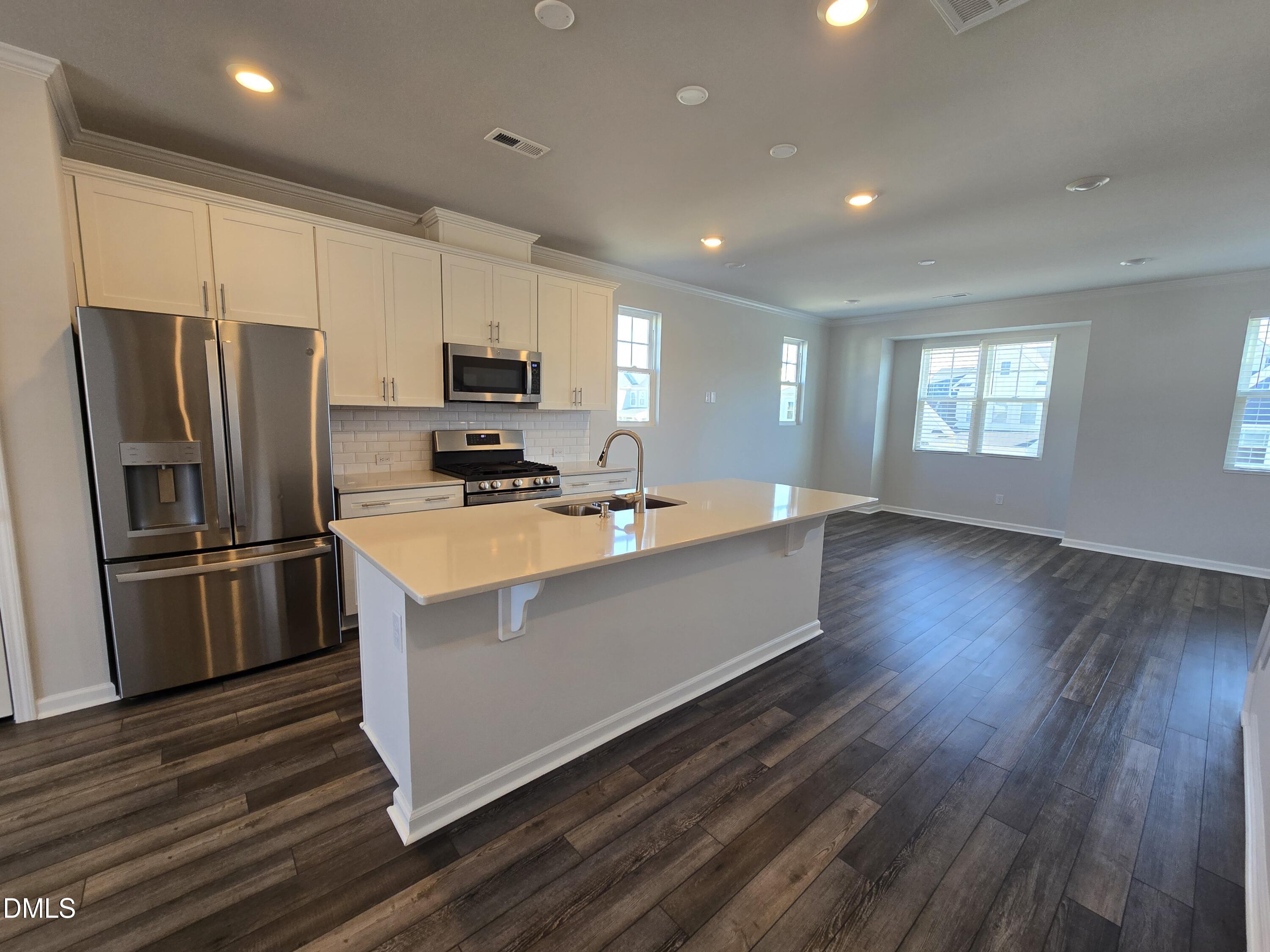 6309 Truxton Lane Raleigh, NC 27616 - Photo 16 of 41 a kitchen with stainless steel appliances a refrigerator stove microwave and cabinets