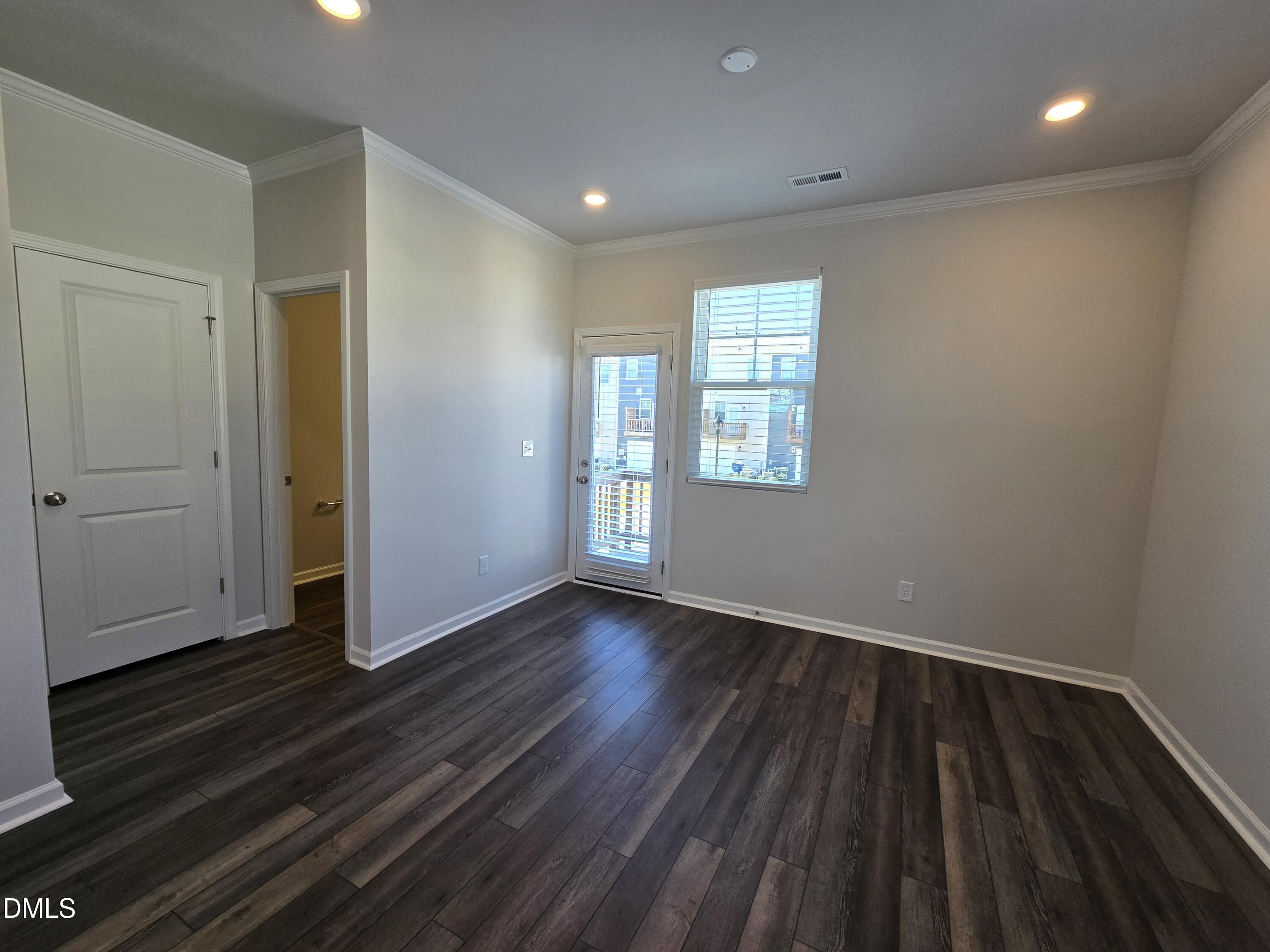 6309 Truxton Lane Raleigh, NC 27616 - Photo 18 of 41 an empty room with wooden floor and windows
